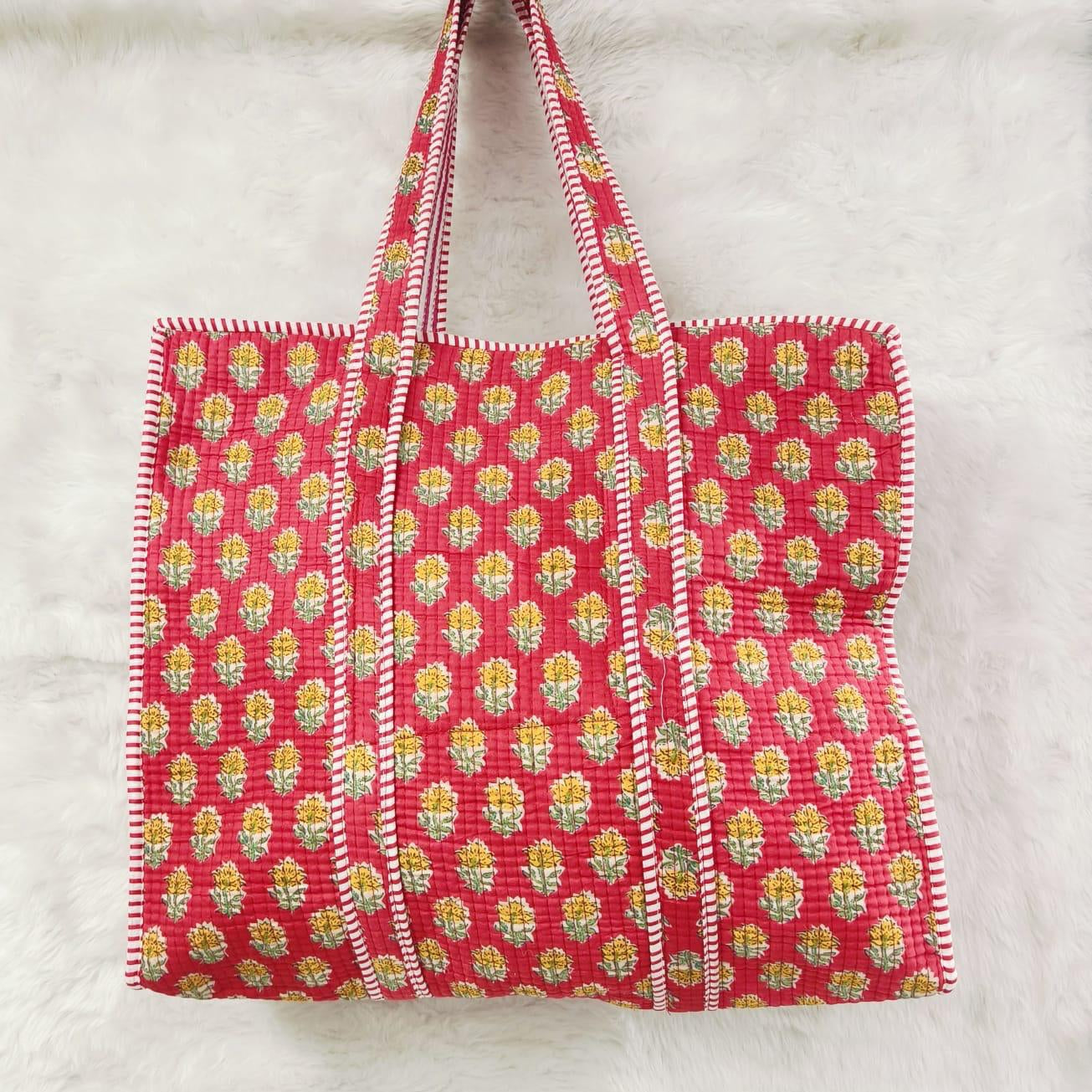Red floral patterned tote bag on a light gray background