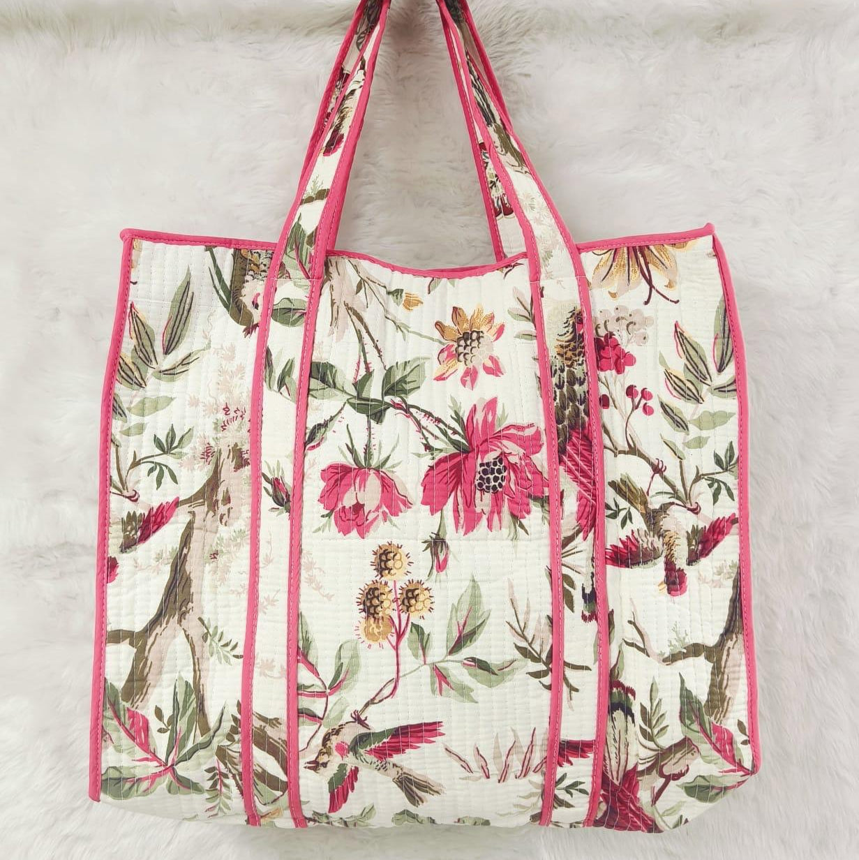Floral-patterned tote bag with pink trim on a light background
