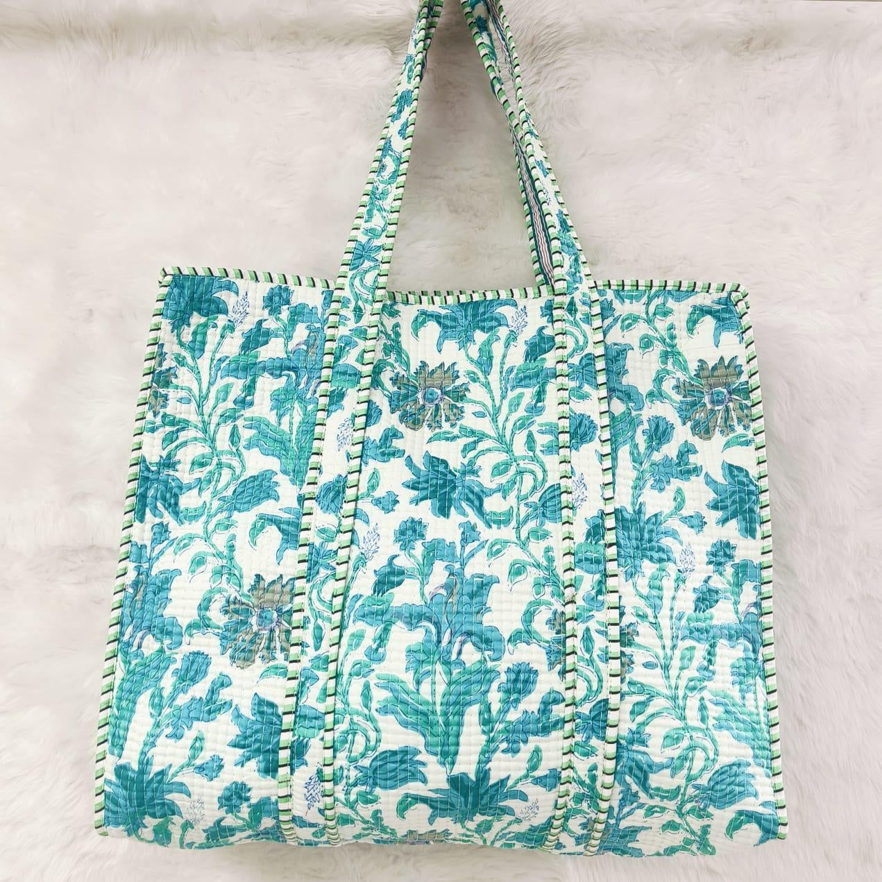 Floral patterned bag with decorative trim on a light background