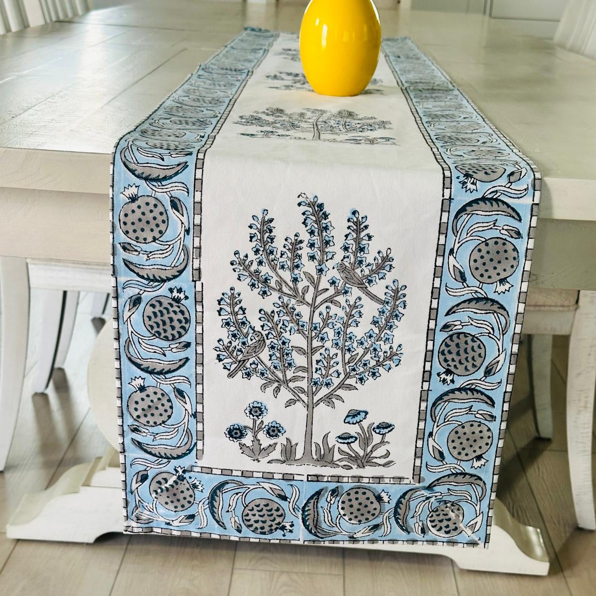 Decorative table runner with floral design on a wooden table