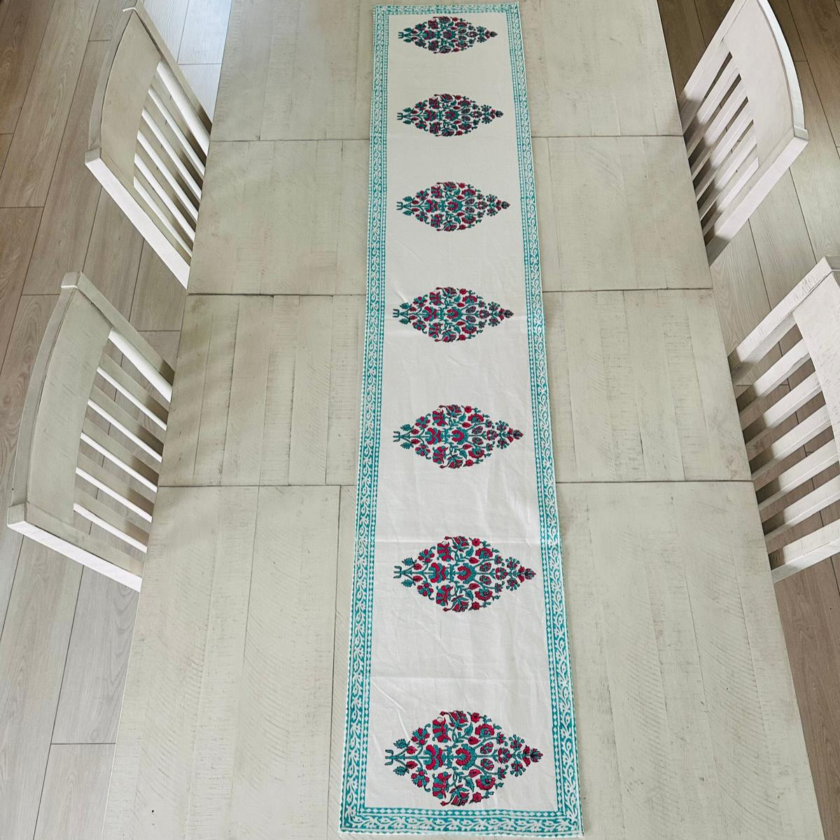 Decorative table runner with geometric pattern on a wooden table