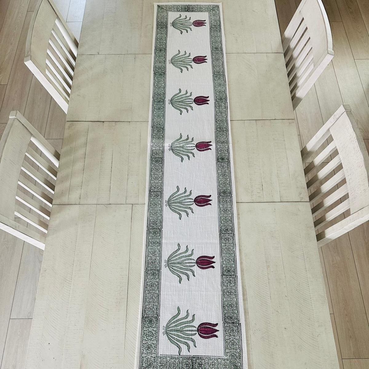 Decorative table runner with floral pattern on a wooden table