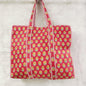 Red floral patterned tote bag on a light gray background