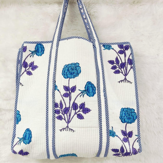 Tote bag with blue floral patterns on a white background
