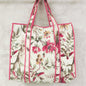 Floral-patterned tote bag with pink trim on a light background