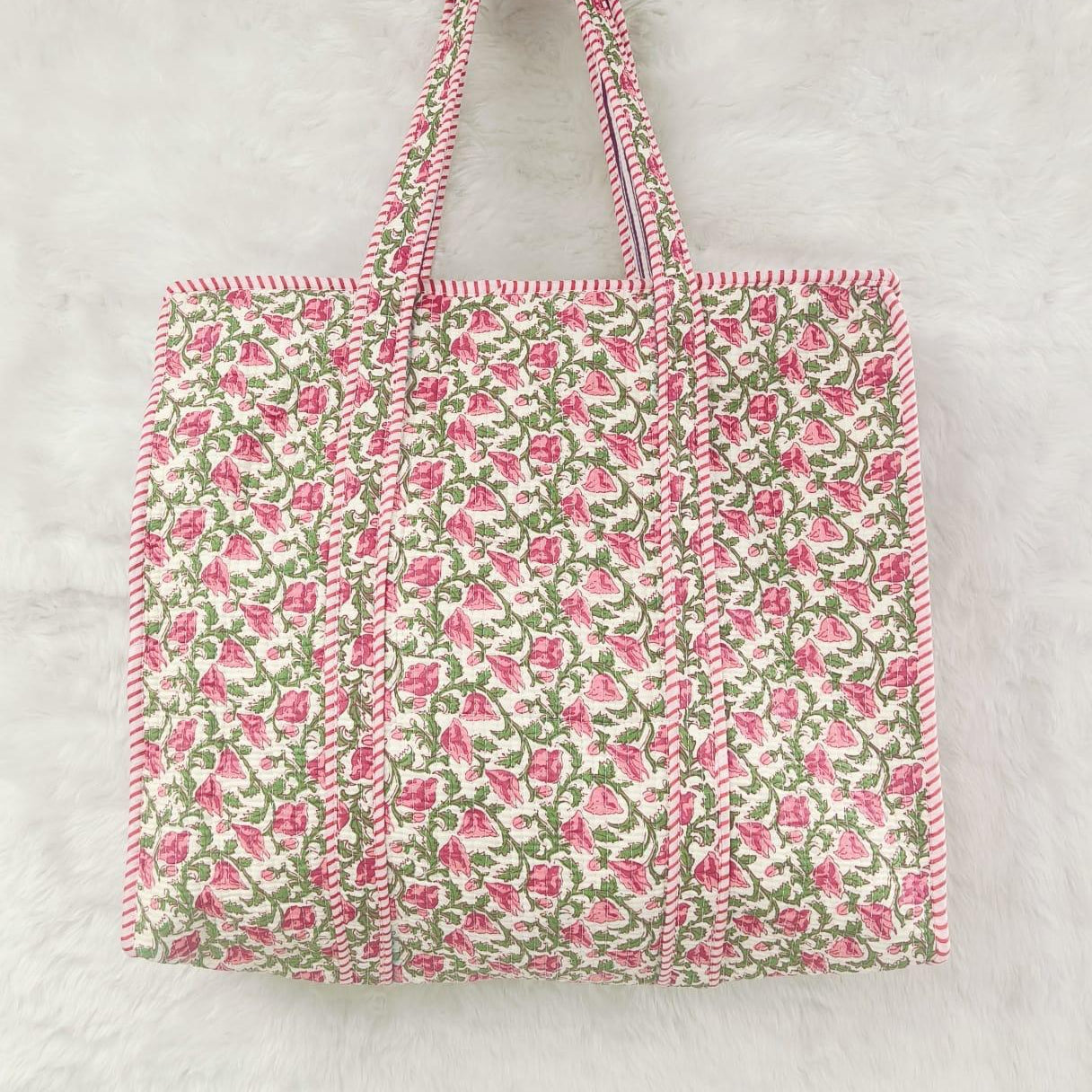 Floral patterned tote bag with pink and green design on a light gray background