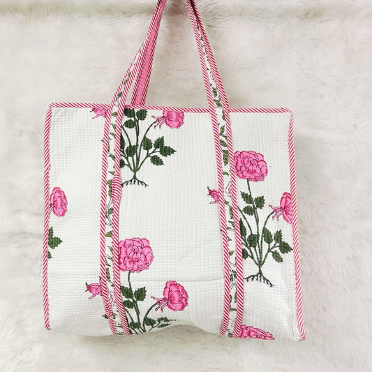Floral-patterned tote bag with pink flowers and green leaves on a white background