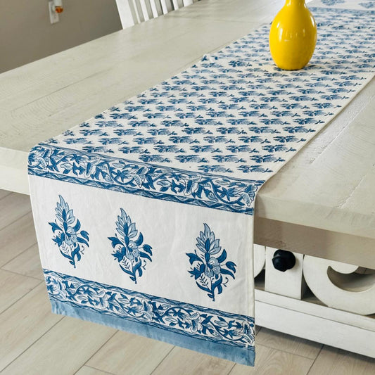 Blue and white patterned table runner on a wooden table