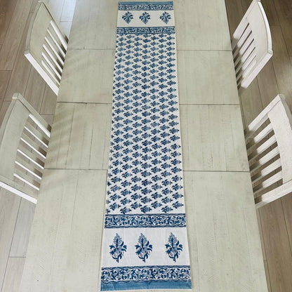 Table runner with blue floral pattern on a wooden table