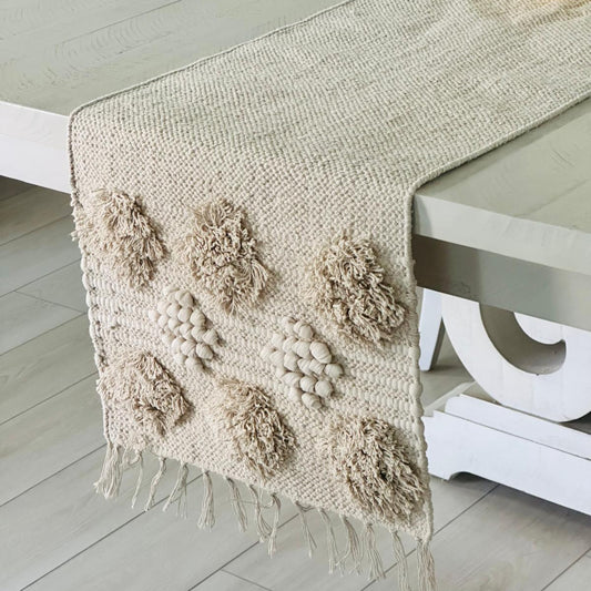 Textured table runner with floral patterns on a white table