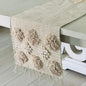 Textured table runner with floral patterns on a white table