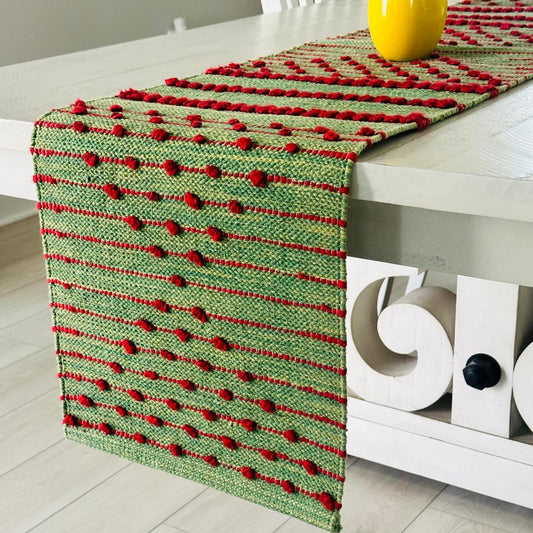 Green and red patterned table runner on a white surface