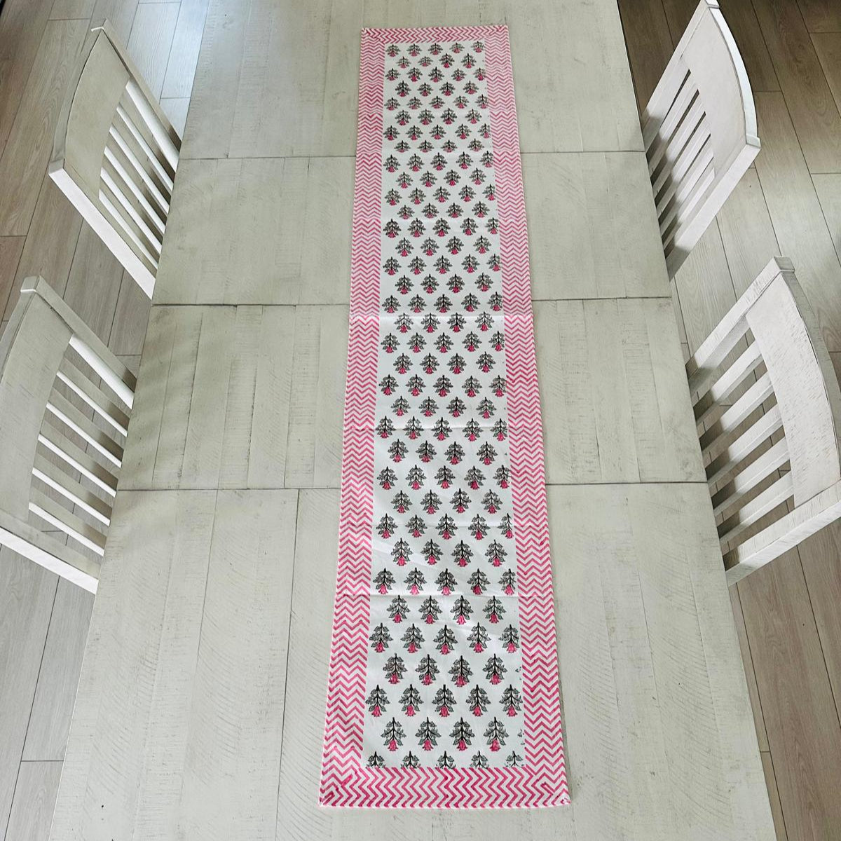 Table runner with a pattern on a wooden table