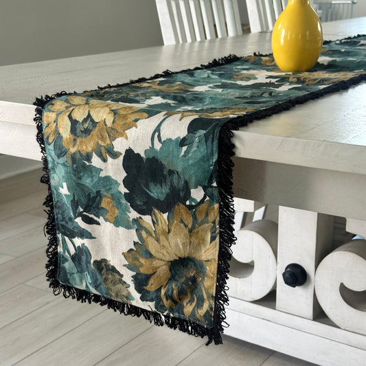 Floral table runner on a dining table with a yellow vase.