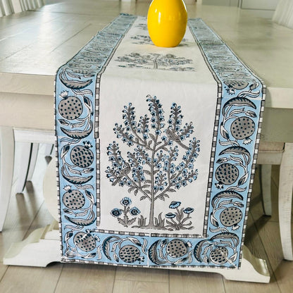 Decorative table runner with floral design on a wooden table