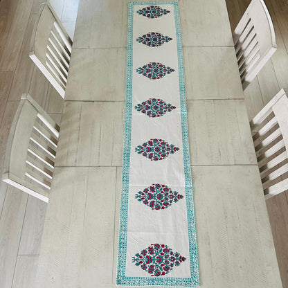Decorative table runner with geometric pattern on a wooden table