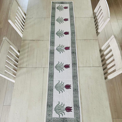 Decorative table runner with floral pattern on a wooden table