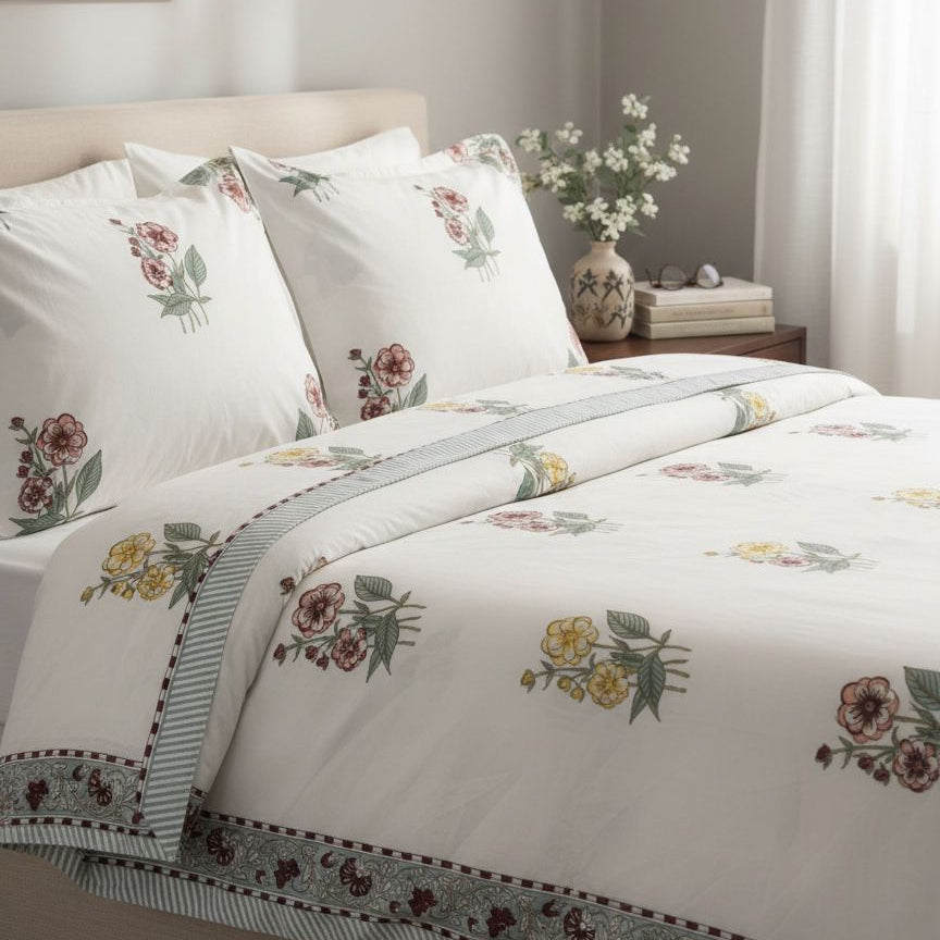 Floral patterned bedding set on a bed in a bedroom setting.