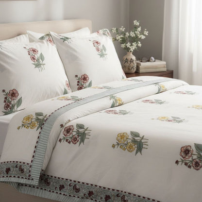 Floral patterned bedding set on a bed in a bedroom setting.