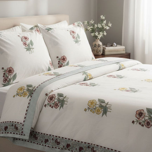 Floral patterned bedding set on a bed in a bedroom setting.