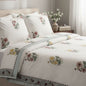 Floral patterned bedding set on a bed in a bedroom setting.
