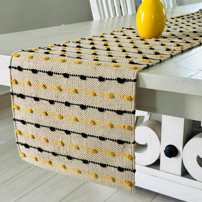 Table runner with yellow and black pattern on a white table