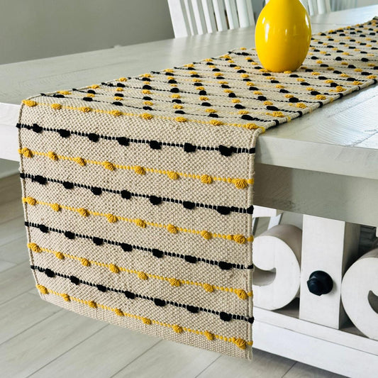 Table runner with yellow and black pattern on a white table