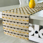 Table runner with yellow and black pattern on a white table