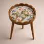 Pink floral side table with scalloped rim and three legs