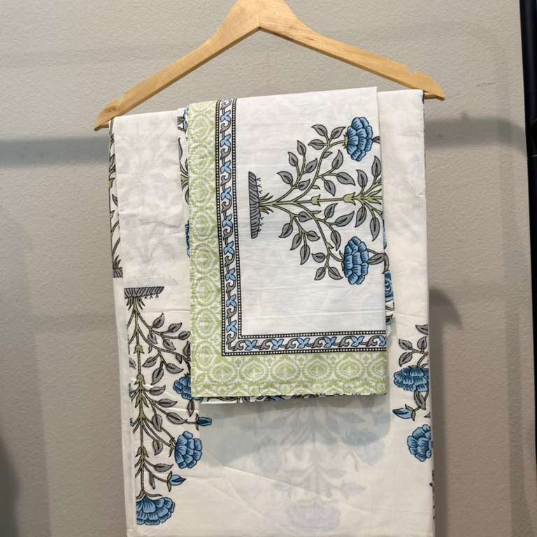 Set of patterned towels on a hanger against a neutral background