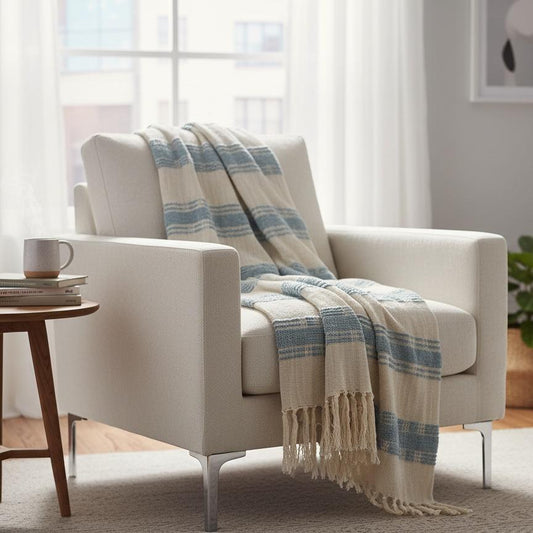 White armchair with a blue and beige plaid blanket in a bright living room.